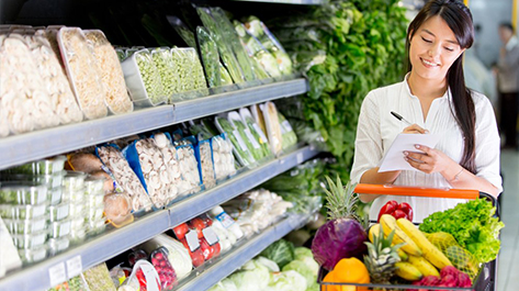 A Woman implementing the tricks to save on your grocery bill at the store