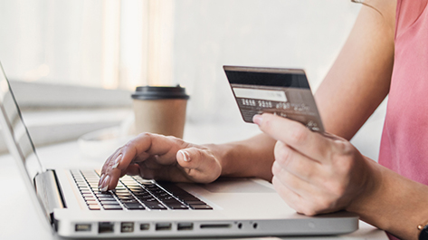 Woman on her laptop to manage her credit cards better with Velocity Community Credit Union