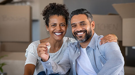 Couple with a key to their new home that has a 15-year mortgage