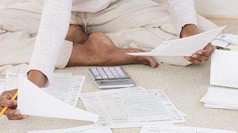 Woman looking over tax paperwork to protect herself from tax scams