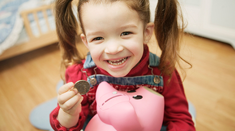 Young girl learning about money through DIY money games