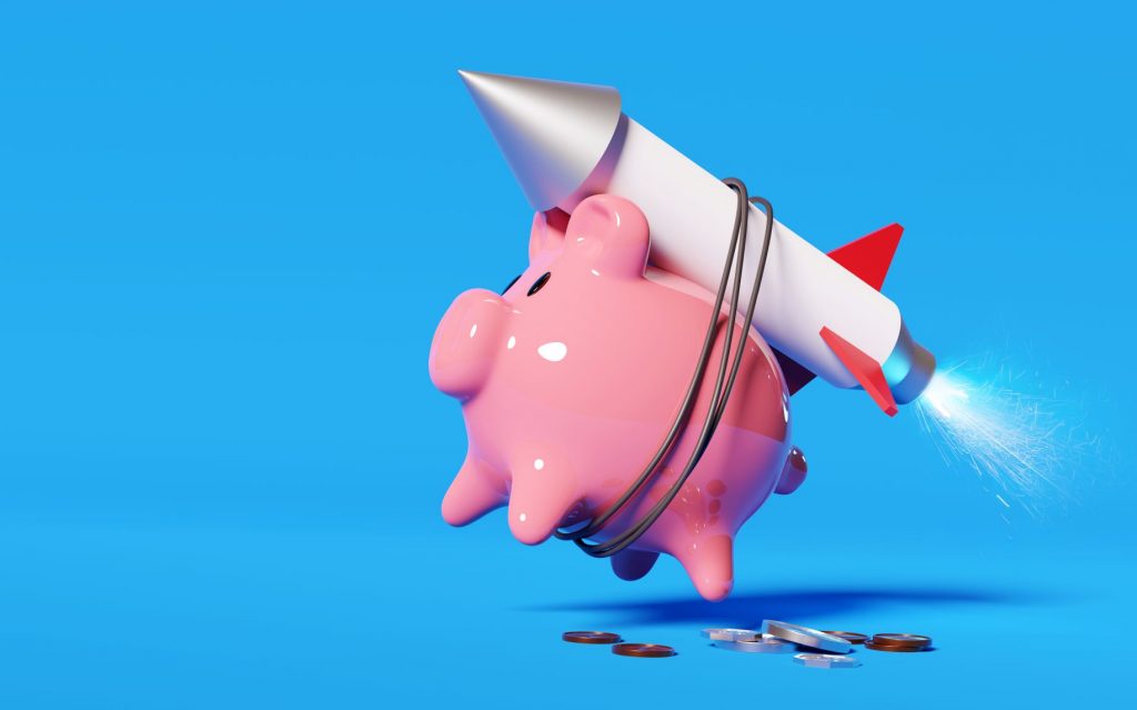 A piggy bank with a rocket tied to its back represents how certificates of deposit can help your savings soar.