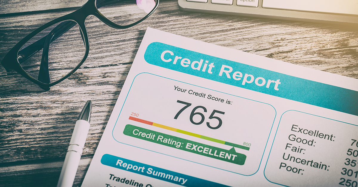 Credit report on a desk showing a score of 765