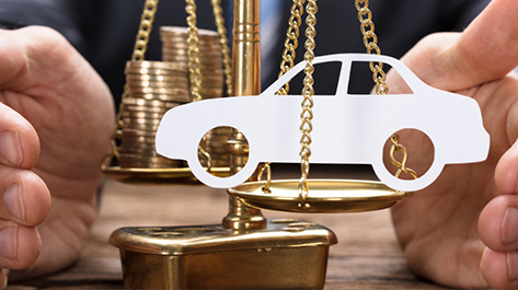 A man working on balancing his paper car with his Velocity Community Car Loan