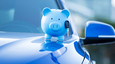 Piggy Bank with key on a blue car
